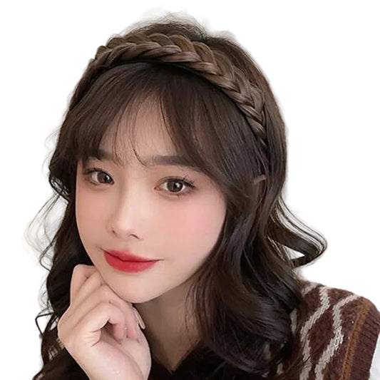 Woman with braided hair wearing a headband against a beige background