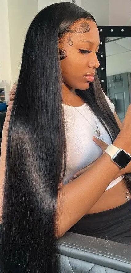 A long, straight black lace wig is shown on a model in a salon setting, with three inset close-up panels labeled Pre-Plucked, Baby Hair Around, and Natural HairLine to demonstrate styling and hairline detail.