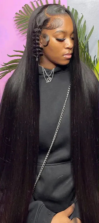 A collage showing a woman modeling a long, straight black lace wig with side-braided detailing. The image includes three panels: a full-length view, a close-up of the hairline, and a side view, all against a pink background with green leaves.